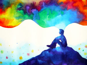 Graphic of man sat on hill with colourful clouds coming out of his head