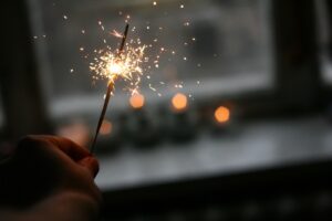 a hand holding a sparkler