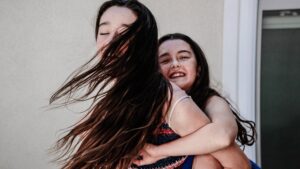 Two young girls playing piggyback