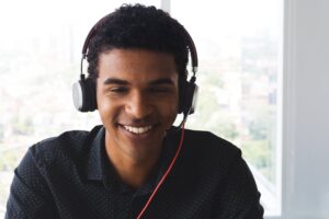 young black man smiling and wearing a headset