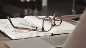 a pair of glasses lying on a notebook