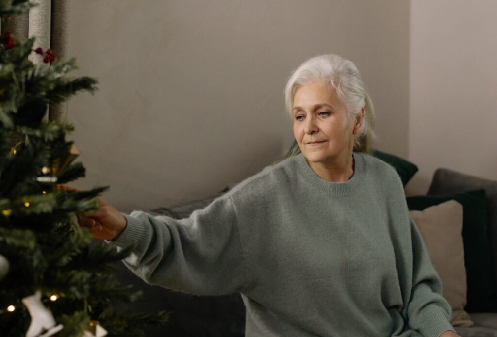 Woman touching a Christmas tree