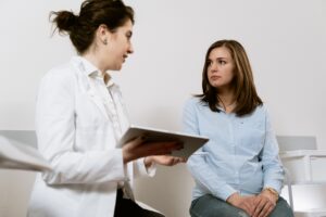 A woman receives a diagnosis with her doctor