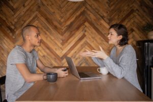 two people discussing across a table